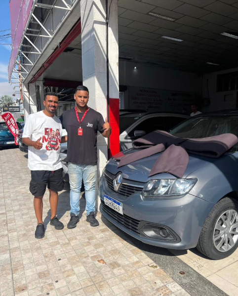 Cliente e vendedor Lucas Martins com Renault Logan na entrega na Jazz Veículos